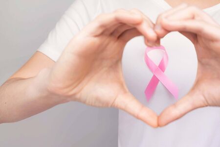 World Breast Cancer Day Concept,health care - woman wore pink t-shirt,Pink ribbon for breast cancer awareness, symbolic bow color raising awareness on people living with women's breast tumor illnessの写真素材