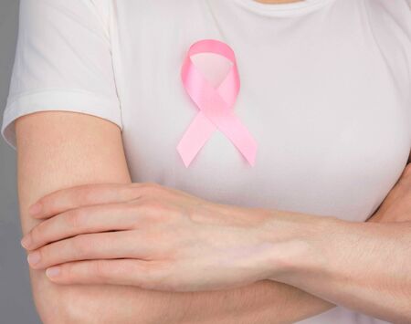World Breast Cancer Day Concept,health care - woman wore pink t-shirt,Pink ribbon for breast cancer awareness, symbolic bow color raising awareness on people living with women's breast tumor illnessの写真素材