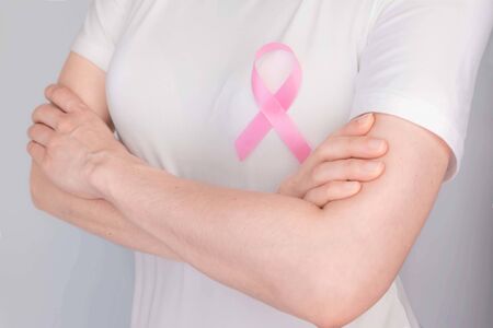 World Breast Cancer Day Concept,health care - woman wore pink t-shirt,Pink ribbon for breast cancer awareness, symbolic bow color raising awareness on people living with women's breast tumor illnessの写真素材
