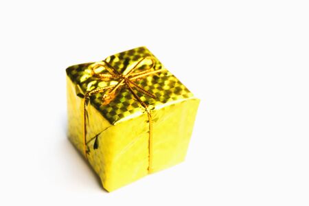 Selective focus,Colorful Gift box wrapped in shiny foil, tied with gold thread.isolated on white...