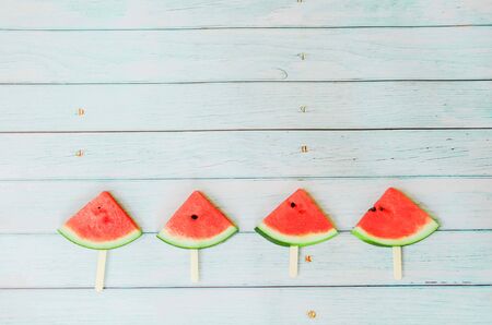 watermelon on blue wooden background  summer holidays vacation conceptの写真素材