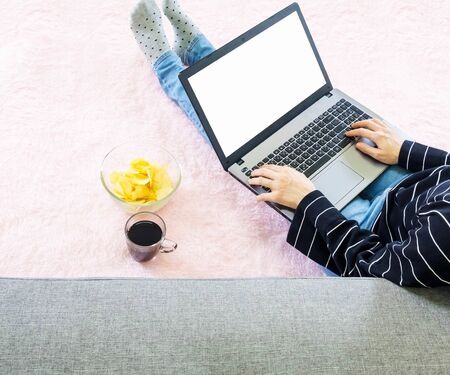 selective focus Crop Young asian woman wore black knitwear and jean, sitting on pink carpet,work...