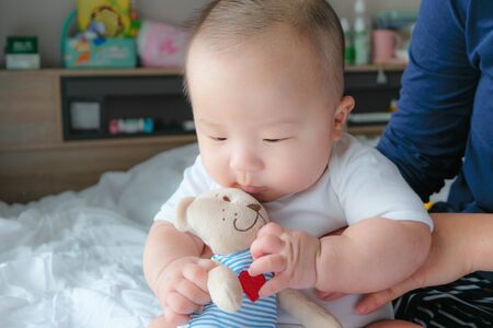 Portrait of a newborn Asian baby boy on the bed , Charming Fat baby 5 month old lies in bed and the...
