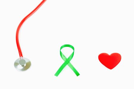health care concept,Red Medical stethoscope,Green ribbon and red heart isolated on white background with copy spaceの写真素材