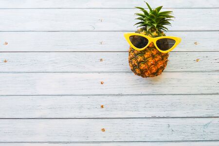 Pineapple on wooden blue background with copy spaceの写真素材