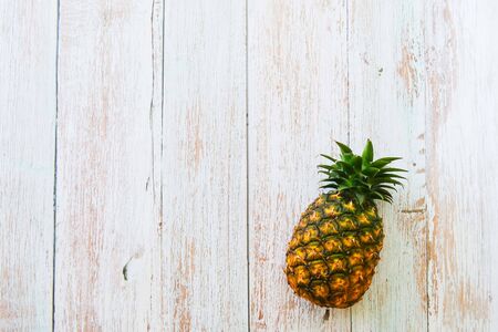 Pineapple on wooden blue background with copy spaceの写真素材