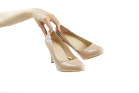 Hand holding  high heels on white backgroundの写真素材