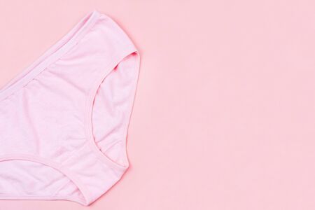 Top view Pink underpants isolated on pink background with copy space. Woman hygiene, Concept of critical days, menstruation,health careの写真素材