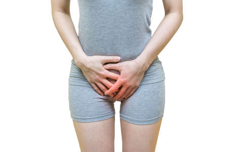 low body of a woman in gray clothes put her hands holding crotch pants,  Itching urinary, Health-care concept on white backgroundの写真素材