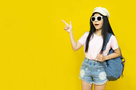 Traveler tourist beautiful young asian woman in casual clothes, cap and sunglasses with backpack...