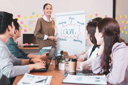 Focus on young asian businesswoman presenting the work,people group have discussion meeting in office.Man and woman have communication brainstorming and working.Business Startup Diversity Conceptの写真素材