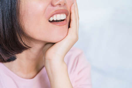 Tooth Pain And Dentistry.woman suffering from toothache, tooth decay or sensitivity.Dental Care And Health Concept.の写真素材