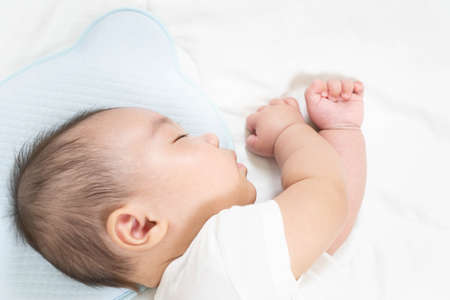 Portrait of a beautiful 4 months newborn smiling, on white background.Cute baby boy smiling.