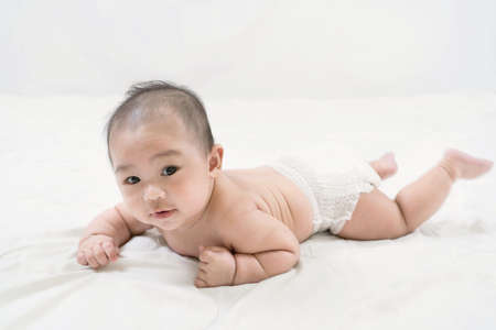 Portrait of a beautiful 4 months newborn smiling, on white background.Cute baby boy smiling.の写真素材