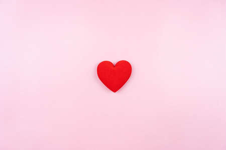 mini red heart on pink backgroundの写真素材