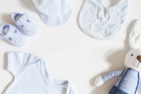 Newborn baby clothing and rabbit toy on white background,Top view, flat lay.の写真素材