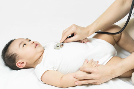 Selective focus on Stethoscope listening to a baby's heart beatの写真素材