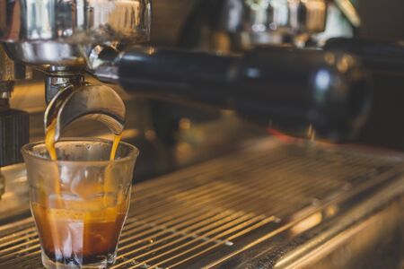 Close-up of espresso pouring from coffee machine.の写真素材