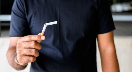 Male hand crushing cigarette. Stop smoking conceptの写真素材