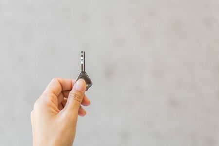 Closeup hand holding a key.