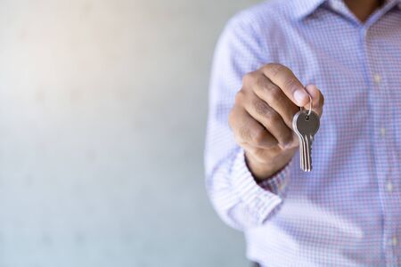 Closeup hand holding a key.