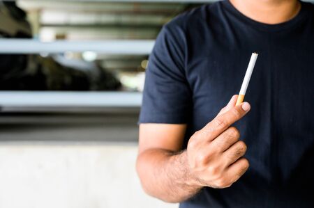 Cigarette in hand man. Stop smoking conceptの写真素材