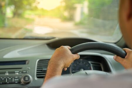 Hands male driving car.