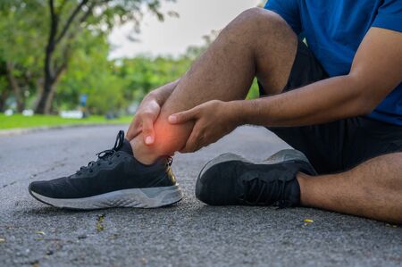 Young healthy man runner  injured their knees from running.の写真素材