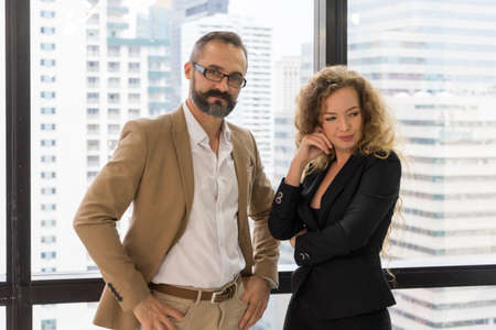 Two businessman and businesswoman business together to create a successful team. Partnership and teamwork concept.の写真素材