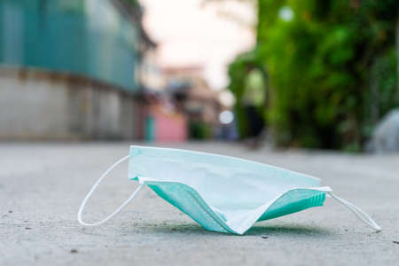 Higienic mask on floor. Disposable hygienic mask. Conceptual hygieneの写真素材