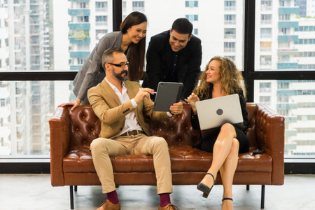 Coworkers team working new startup project at modern office. Analyze business people documents, using touch tablet and laptop. Business meeting concept.の写真素材