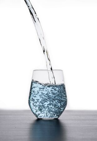 Fill blue water into a glass.の写真素材