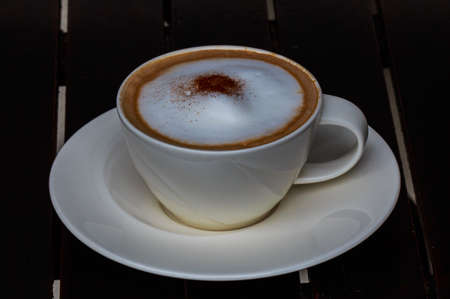 coffee cup on wooden table on brown backgroundの写真素材