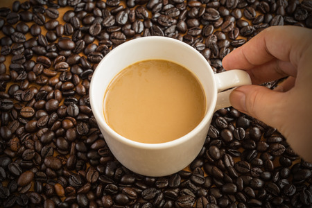 Hot latte coffee cup on coffee beans background.の写真素材