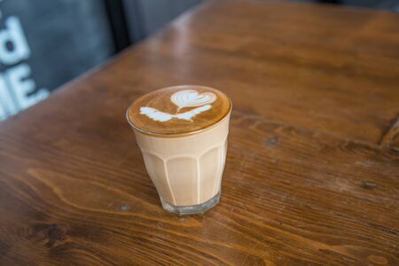 coffe latte cup on a wood table