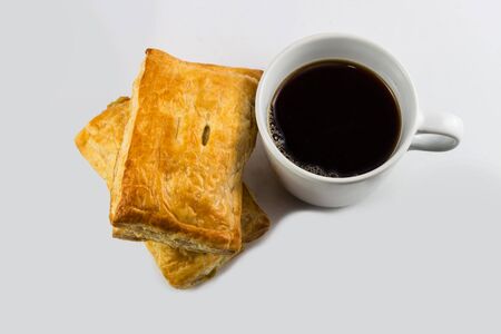 Closeup black coffee and chicken pie isolated on white background