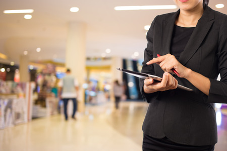 Businesswoman using digital tablet in the shopping mall.の写真素材