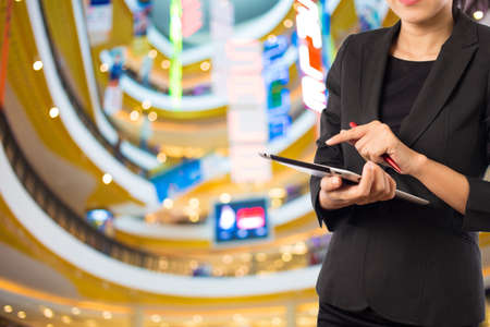 Businesswoman using digital tablet in the shopping mall.の写真素材