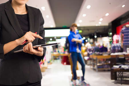 Businesswoman using digital tablet in the shopping mall.の写真素材