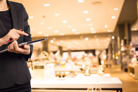 Woman using tablet in shopping mall.の写真素材