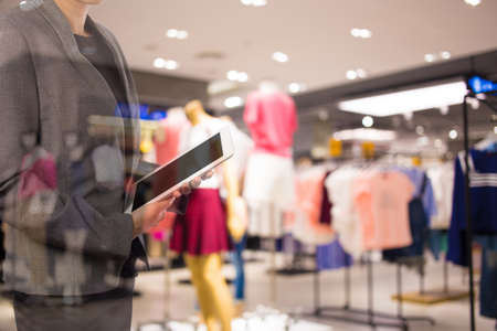 Woman using tablet in shopping mall.の写真素材