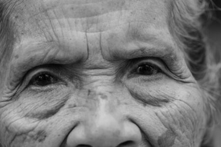 portrait of an asian senior woman, black and white background.の写真素材
