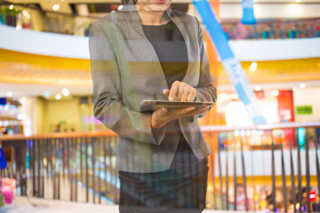 Businesswoman using digital tablet in the shopping mall.の写真素材