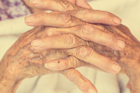 Hand of woman touching senior woman in clinic. : Vintage filterの写真素材