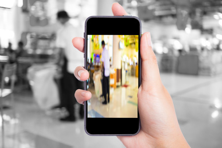 Taking picture with mobile, smart phone in shopping mall.の写真素材