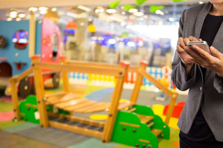Businesswoman using smart phone in shopping mall.の写真素材