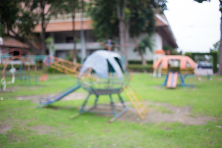 Defocused and blur image of children's playground at public park for background usage.の写真素材