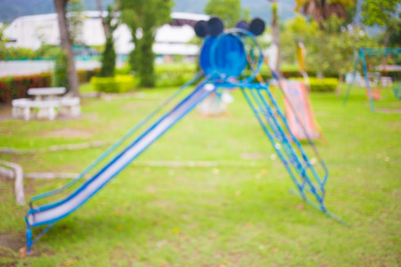 Defocused and blur image of children's playground at public park for background usage.の写真素材