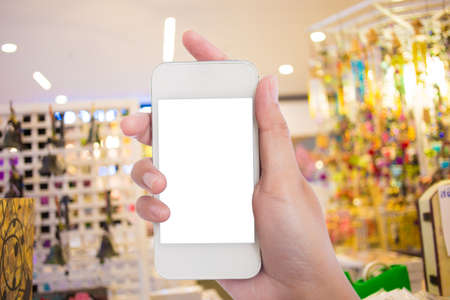 Photo blank. Women hand holding blank mobile smart phone in the shopping mall.