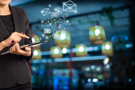 Business woman sending email by using digital tablet